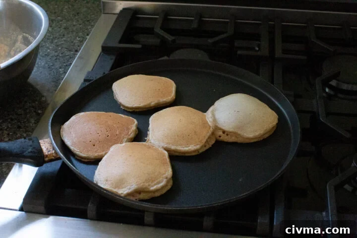 whole wheat pancakes cooking until golden