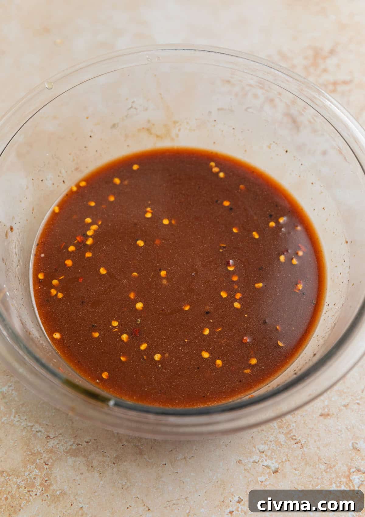 Cashew chicken sauce prepared in glass mixing bowl.