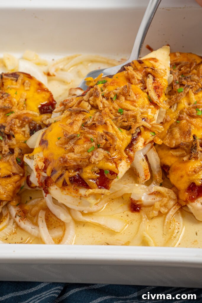 A cheesy barbecue chicken breast on a spatula.