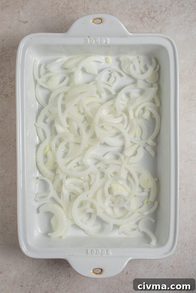 Adding sliced onions to a casserole dish.