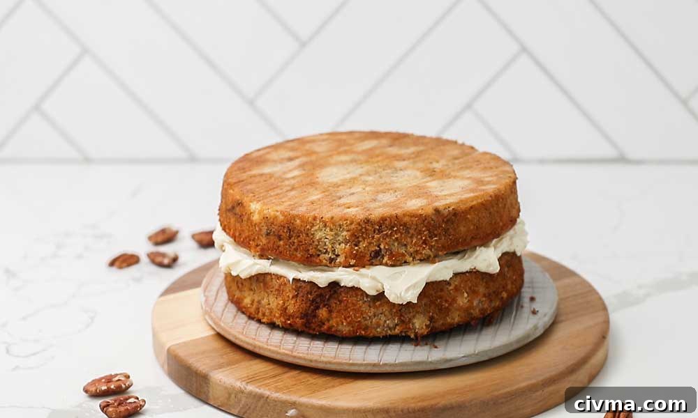 Adding the second layer of cake on top of the filling.