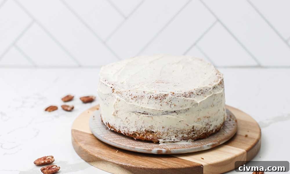 A layer cake shown with a thin layer of frosting known as a crumb coat.
