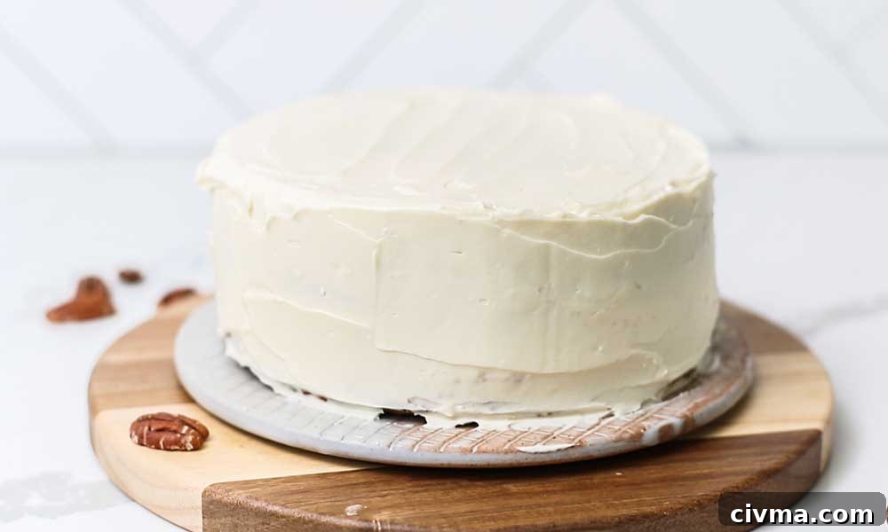 A layer cake shown iced with a thick layer of cream cheese.