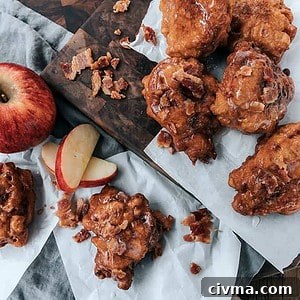 bacon apple fritters stacked on wooden platter