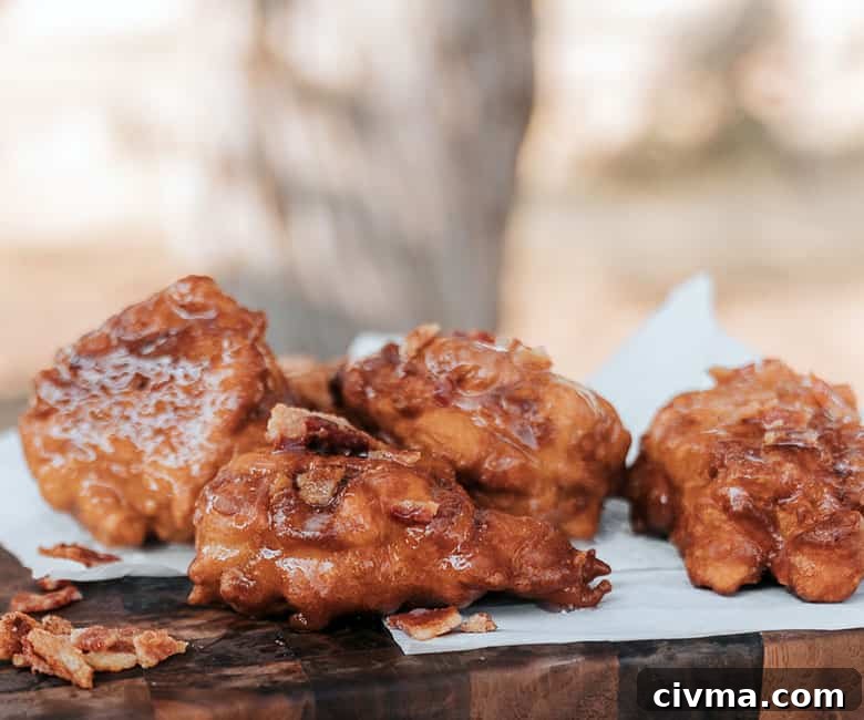 bacon apple fritters stacked on wooden platter
