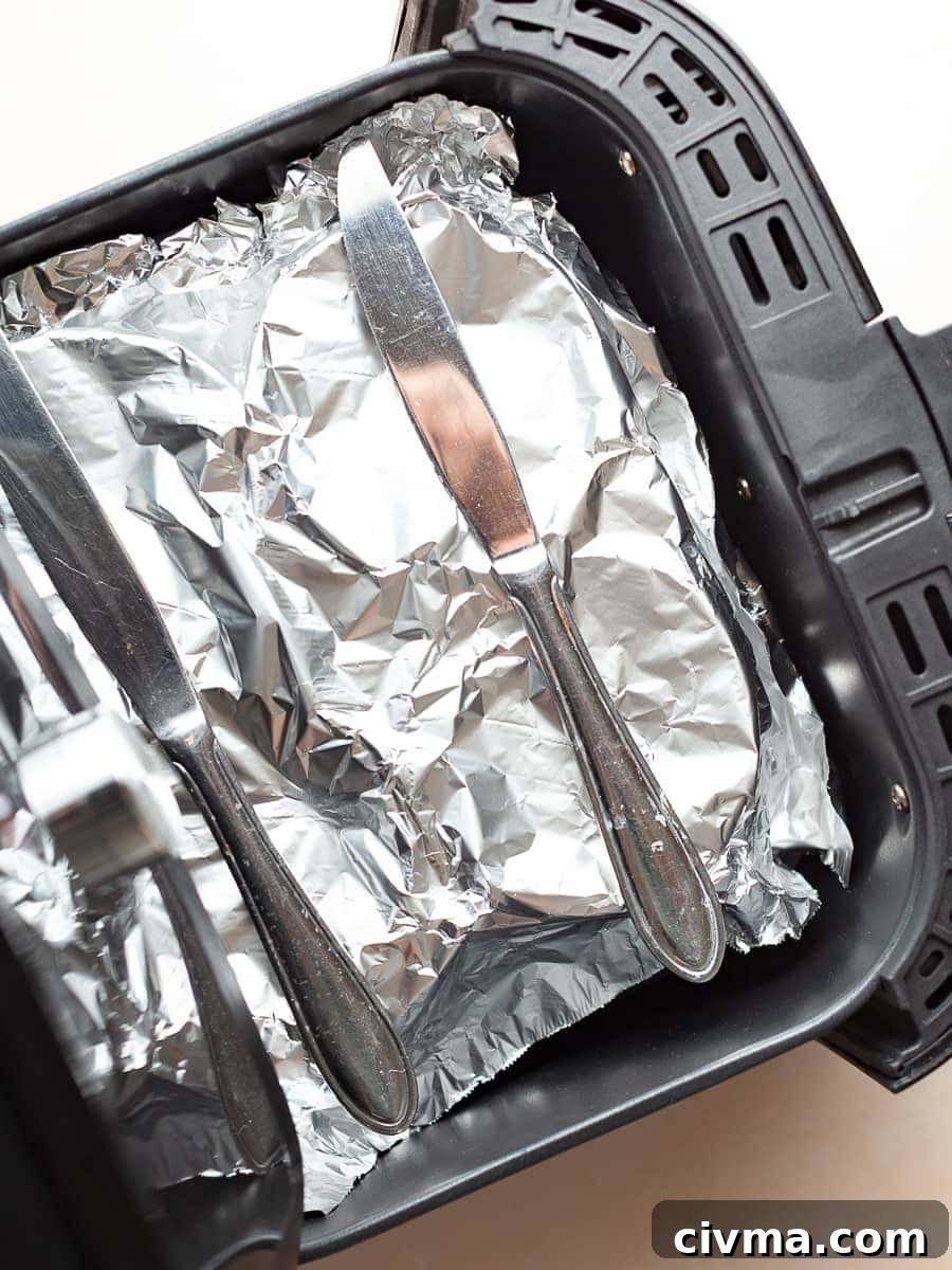 Gluten Free Air Fryer Chocolate Cake Recipe 12 ramekins covered with foil in the air fryer