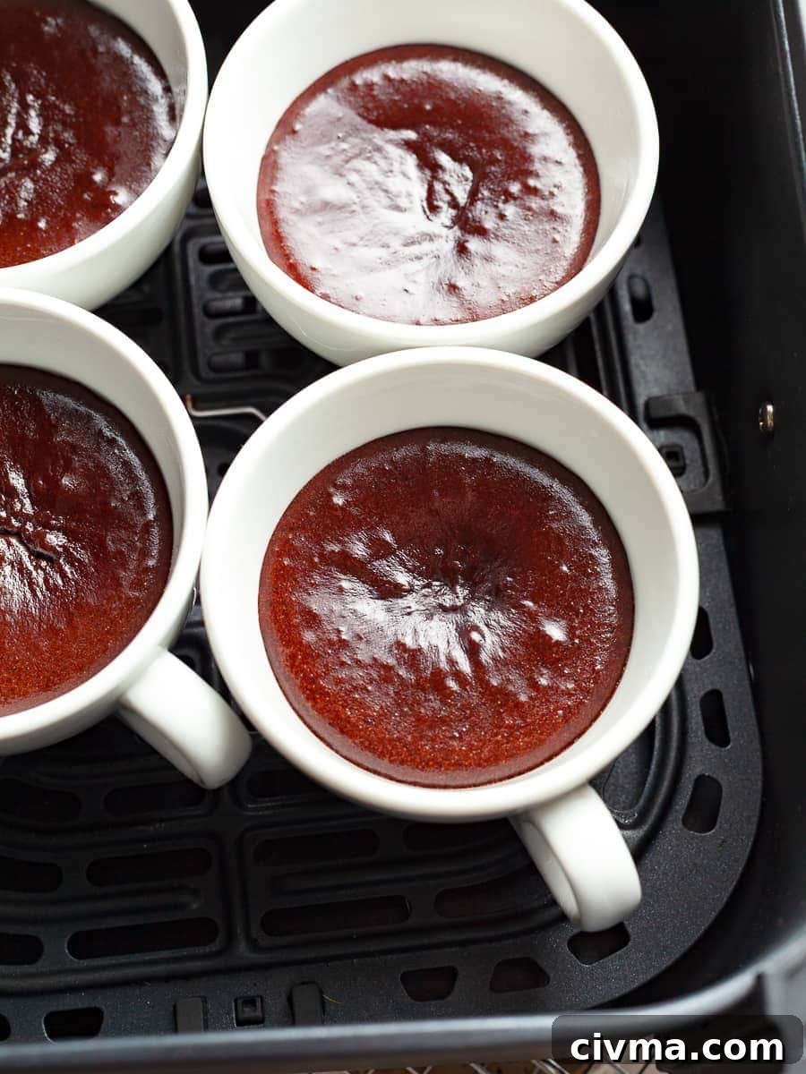 Gluten Free Air Fryer Chocolate Cake Recipe 13 foil being removed from air fryer chocolate cakes