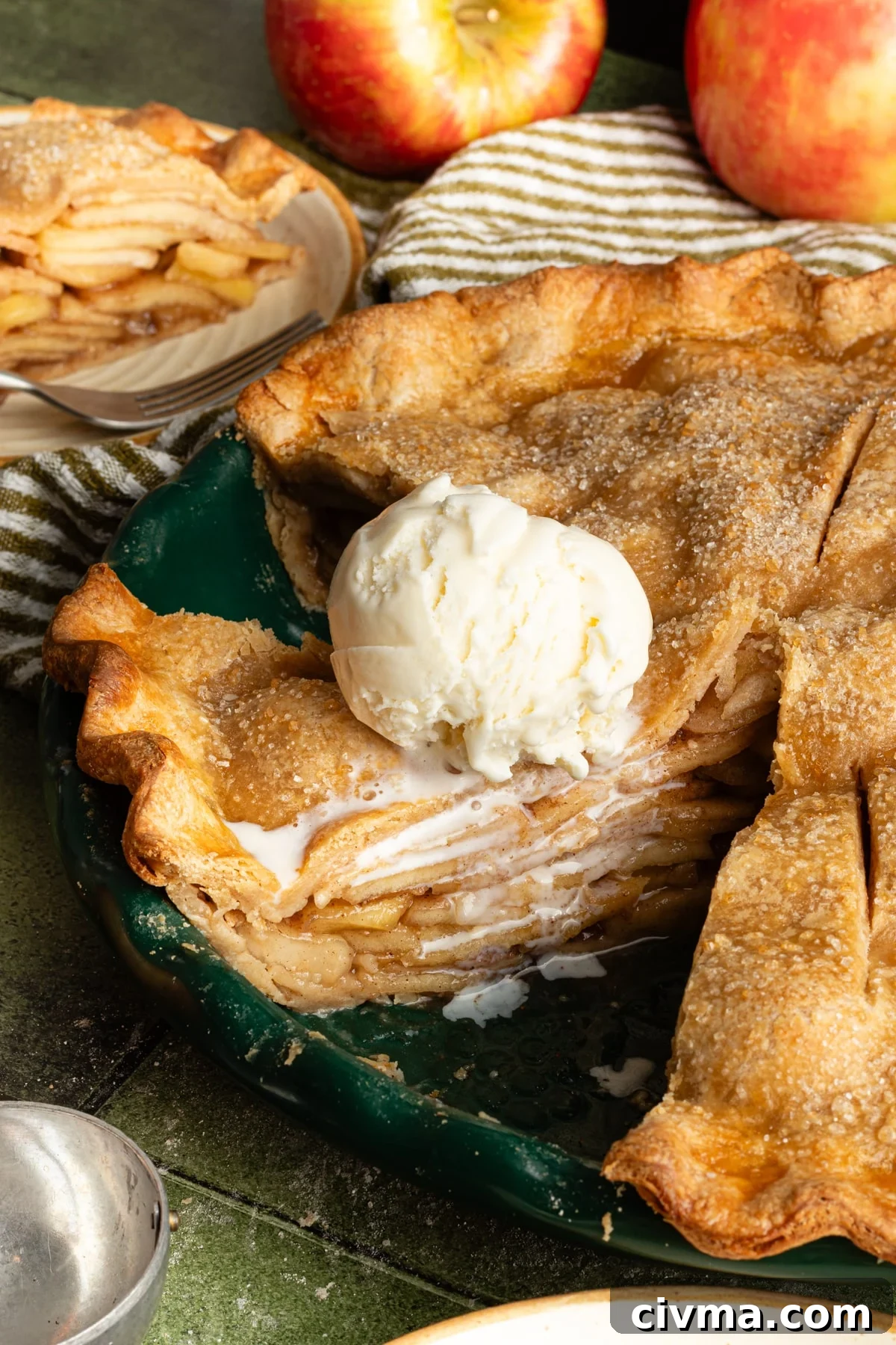 Apple Pie Recipe with Less Sugar and Flaky Crust 2 Healthy apple pie sliced in a dish and topped with vanilla ice cream.