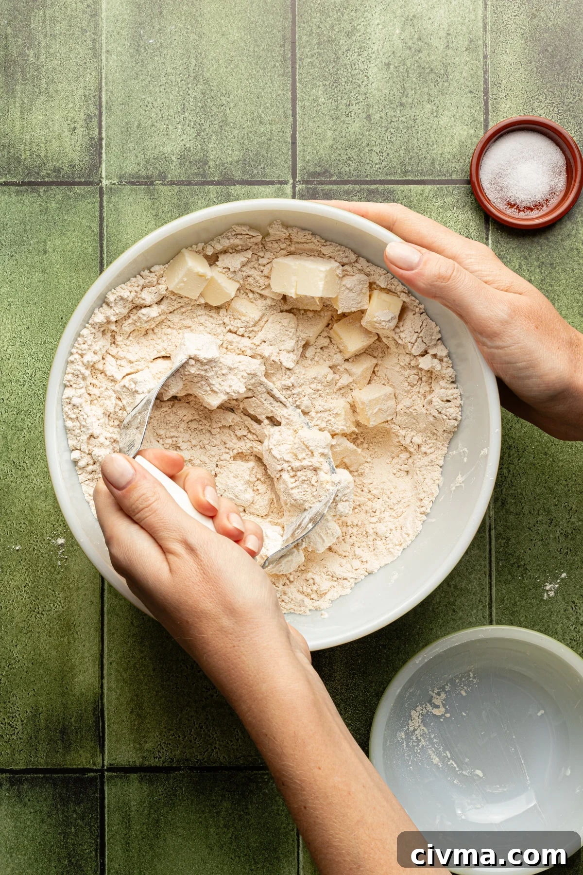 Apple Pie Recipe with Less Sugar and Flaky Crust 5 Whole wheat pastry flour and salt with butter being mixed in with a pastry cutter.