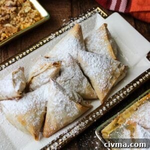 Milopitakia Greek Mini Apple Pies with Phyllo 18 Mini apple pies with phyllo on a white platter.