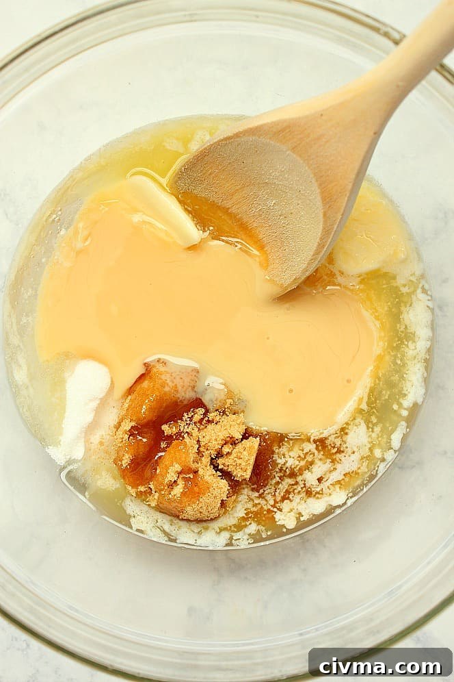 How to make chocolate caramel cups Overhead shot of glass bowl with melted butter, brown sugar and condensed milk.