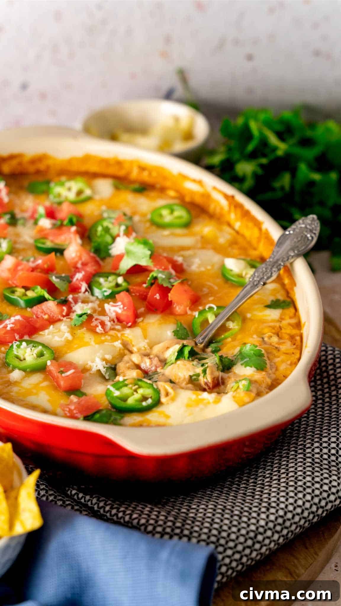 A serving spoon in a baking dish of bean dip.