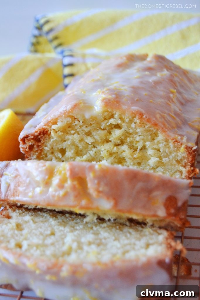 closeup shot of lemon loaf on wire rack with slices cut from it