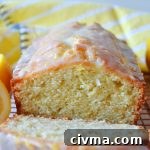 lemon loaf cake with a slice cut off the end of it