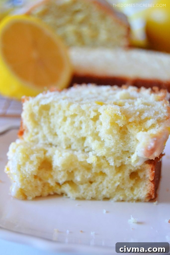 lemon loaf slice cut in half and stacked on a white plate