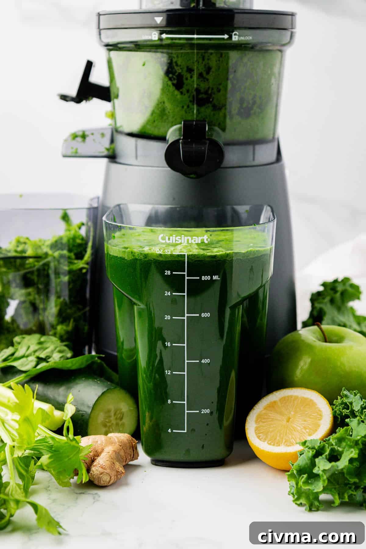 green juice next to a juicer