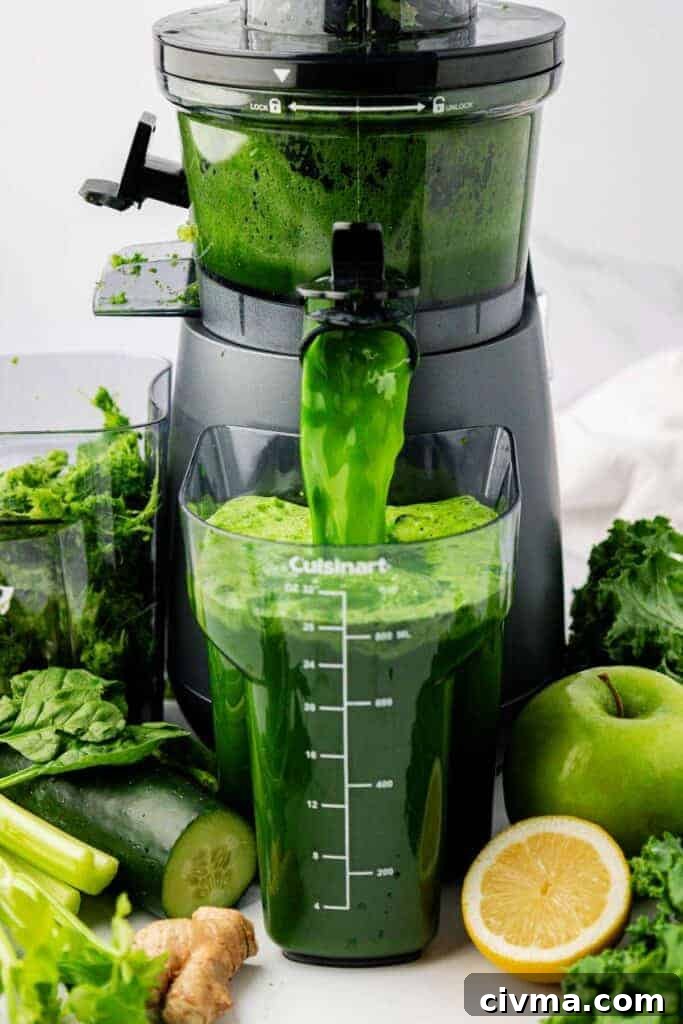 green juice pouring out of a juicer