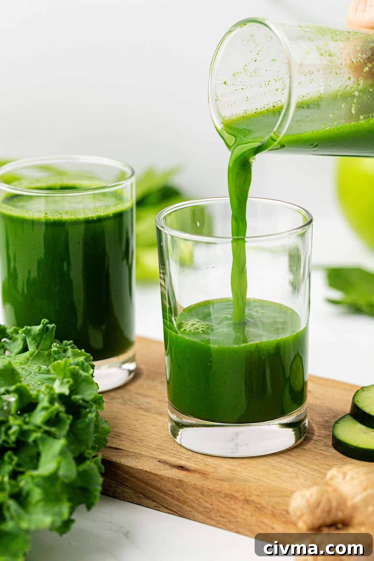 pouring green juice in a glass