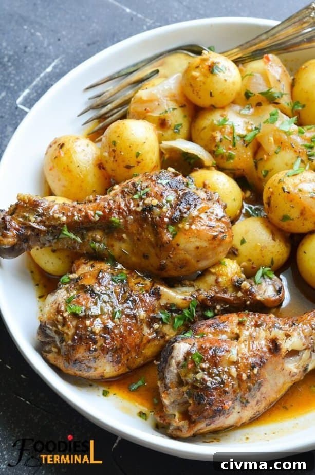 instant pot chicken drumsticks and potatoes served in a white plate with a pair of fork