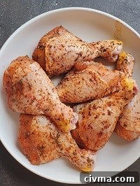 seasoned chicken drumsticks on a white plate