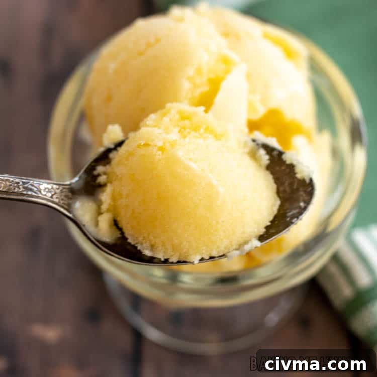 Creamy Mango Coconut Ice Cream Recipe 14 spoon with a bite of mango coconut ice cream