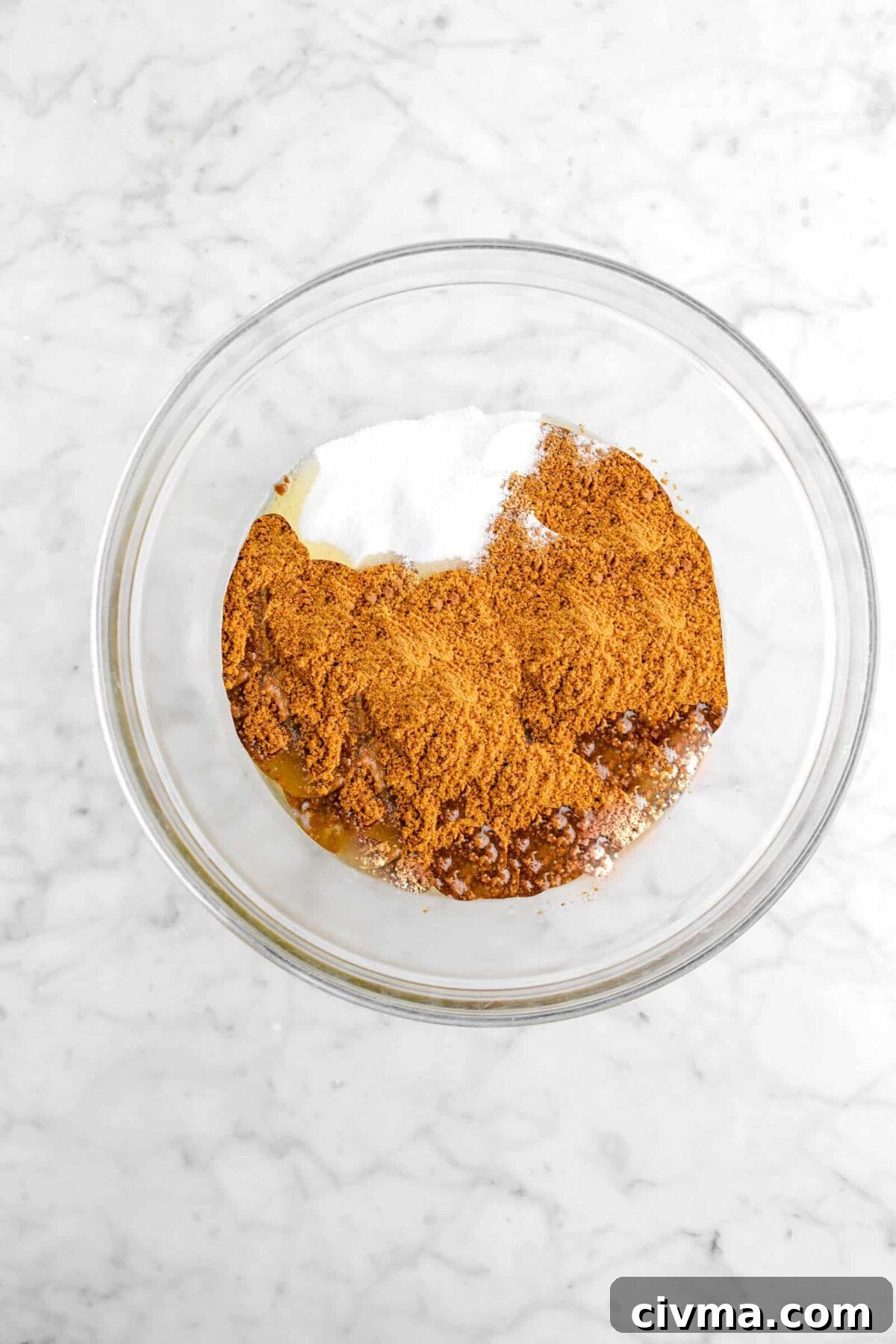 sugar, gingerbread cookie crumbs, and butter in glass bowl