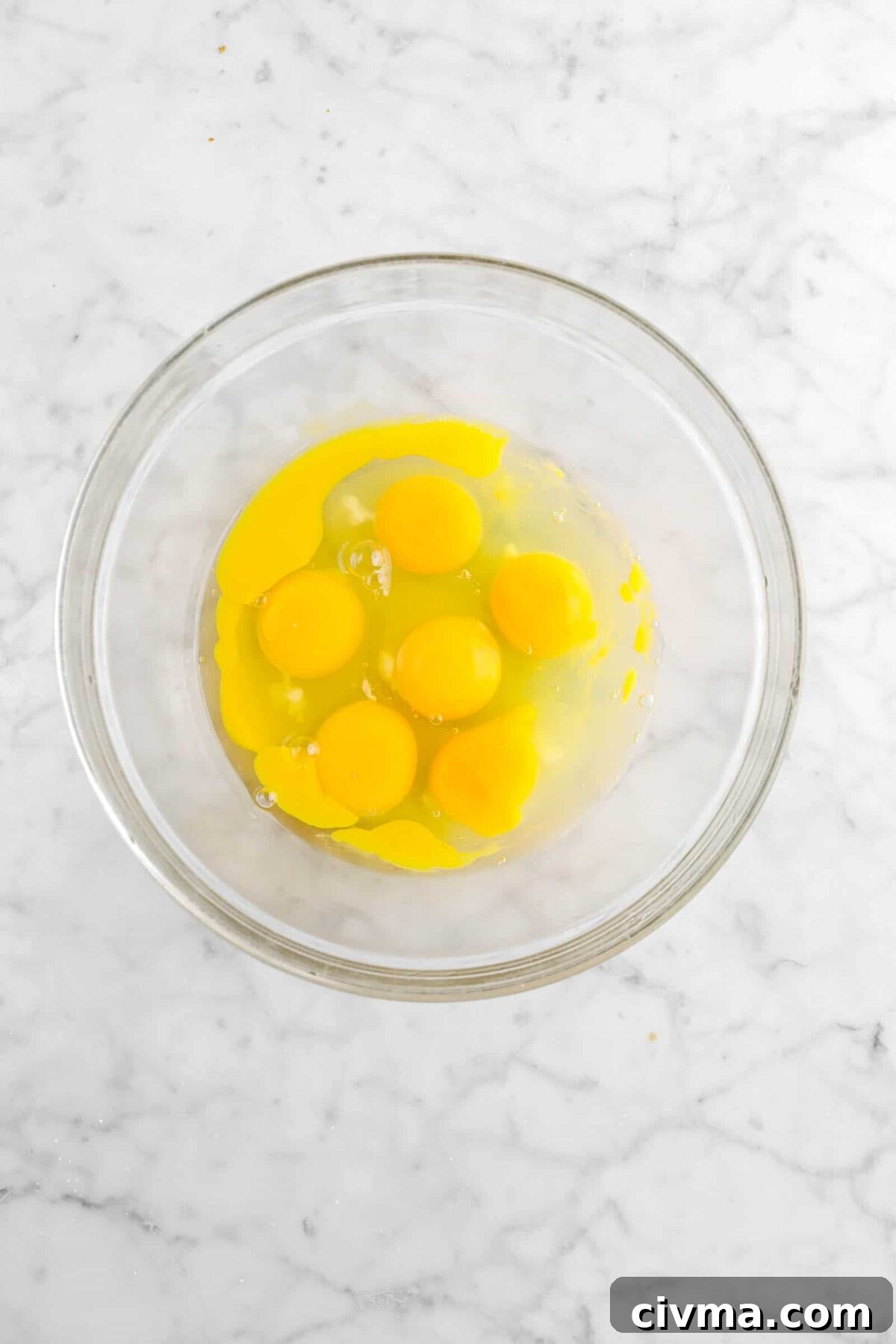 eggs and egg yolks in glass bowl