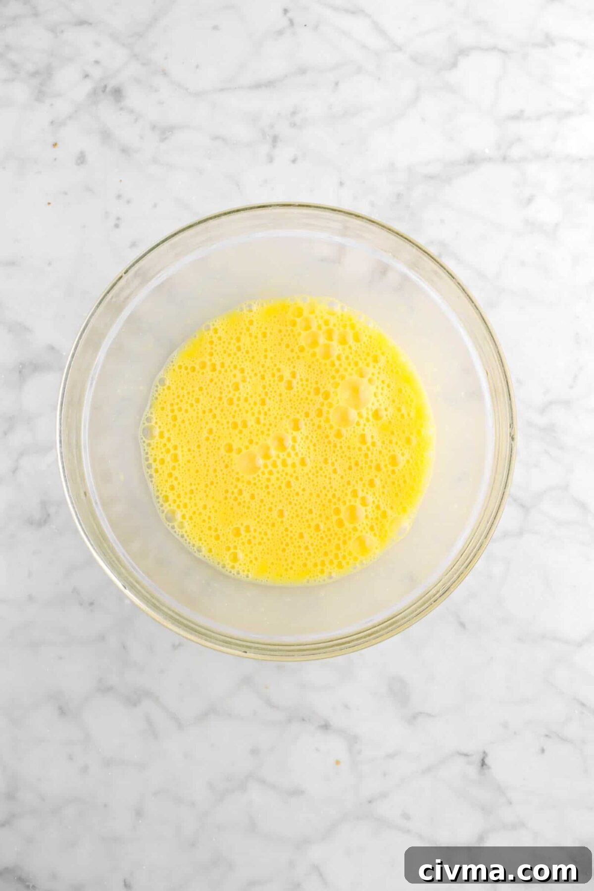 whisked eggs in glass bowl