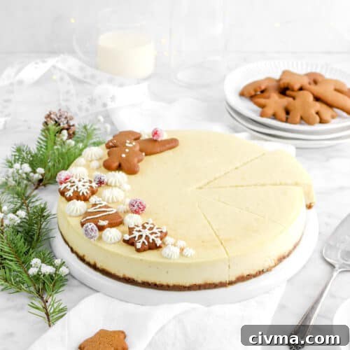pulled back shot of eggnog cheesecake on white plate with three slices cut, pine branches beside, a plate of cookies, glass of eggnog, and white ribbon behind