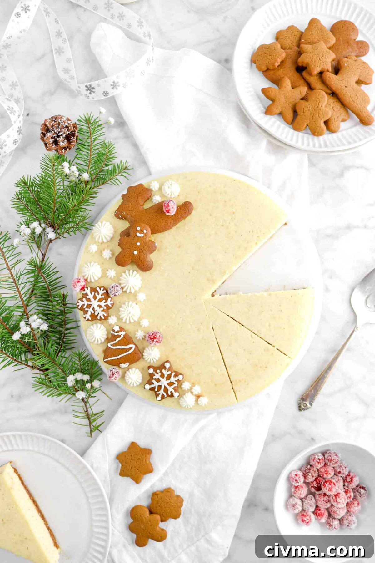 flat lay of cheesecake with three slice cut, one removed and on white palte, with plate of cookies and bowl of sugared cranberries