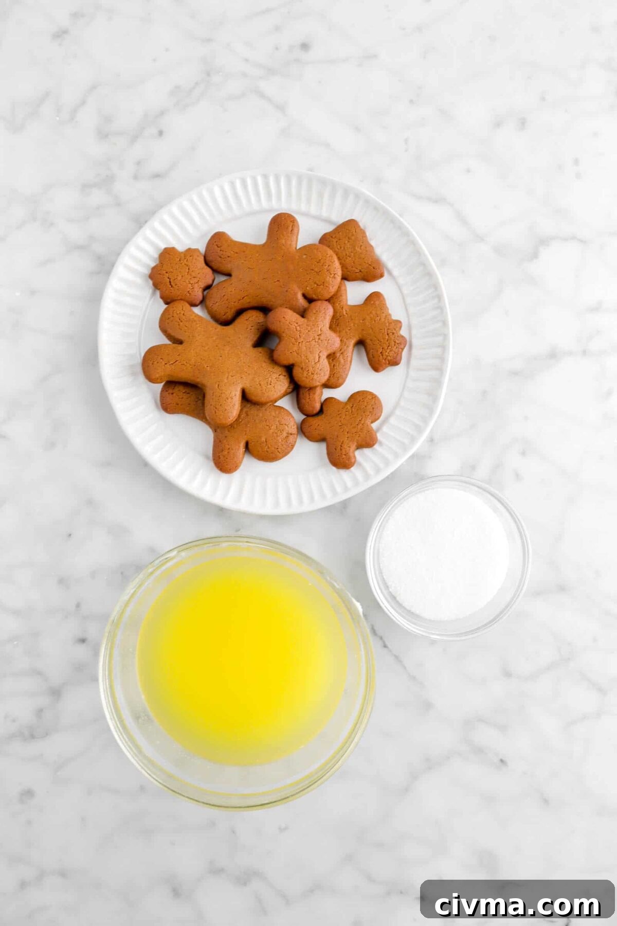 gingerbread cookies, sugar, and melted butter on marble counter
