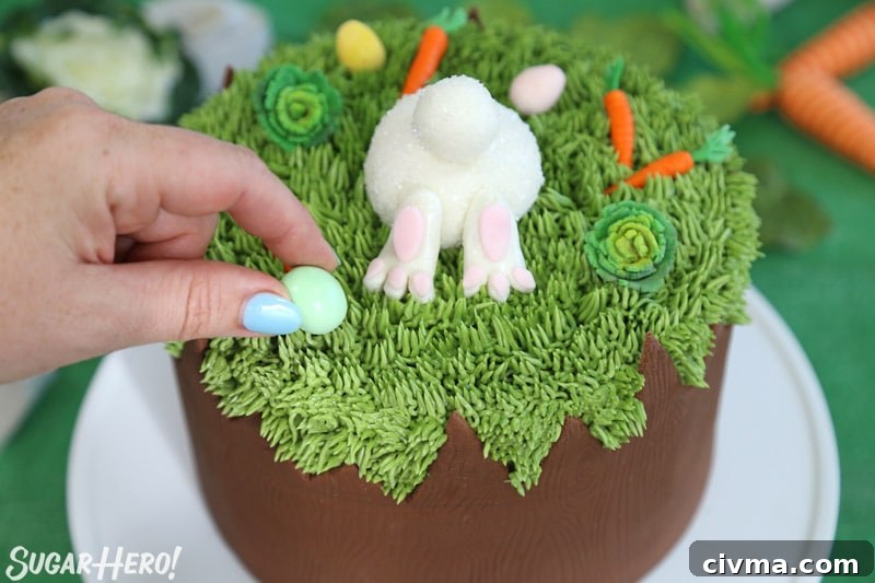 Placing a chocolate egg on top of the Chocolate Easter Bunny Cake