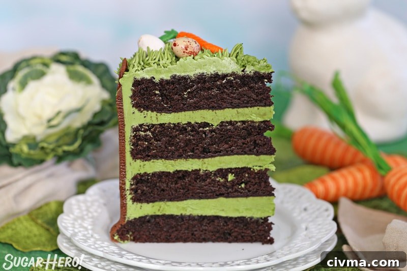 A single slice of Chocolate Easter Bunny Cake, with green frosting in between each chocolate cake layer