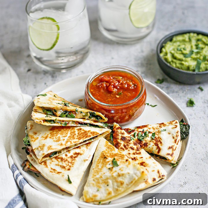 photo of veggie quesadilla on a plate with salsa and guacamole