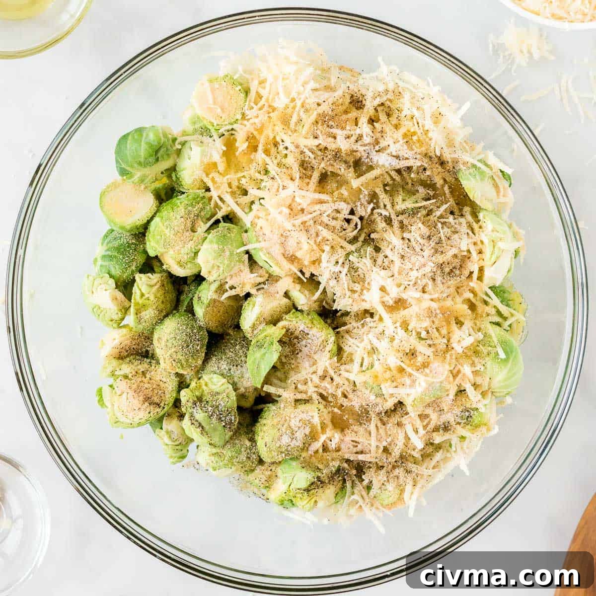 adding the cheese and spices to the brussels sprouts