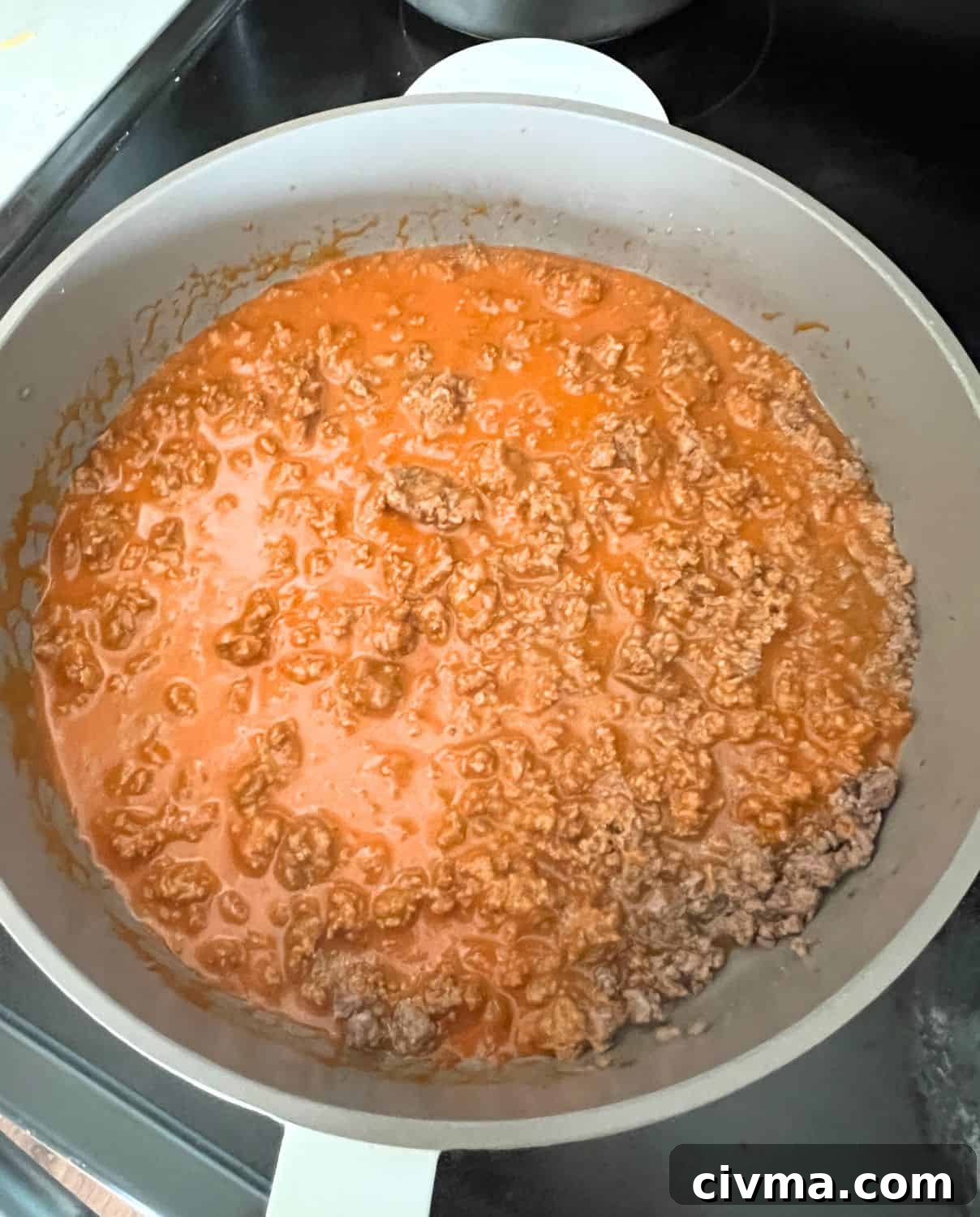 Bubble Up Enchilada Casserole 4 Ground beef and enchilada sauce in a skillet.