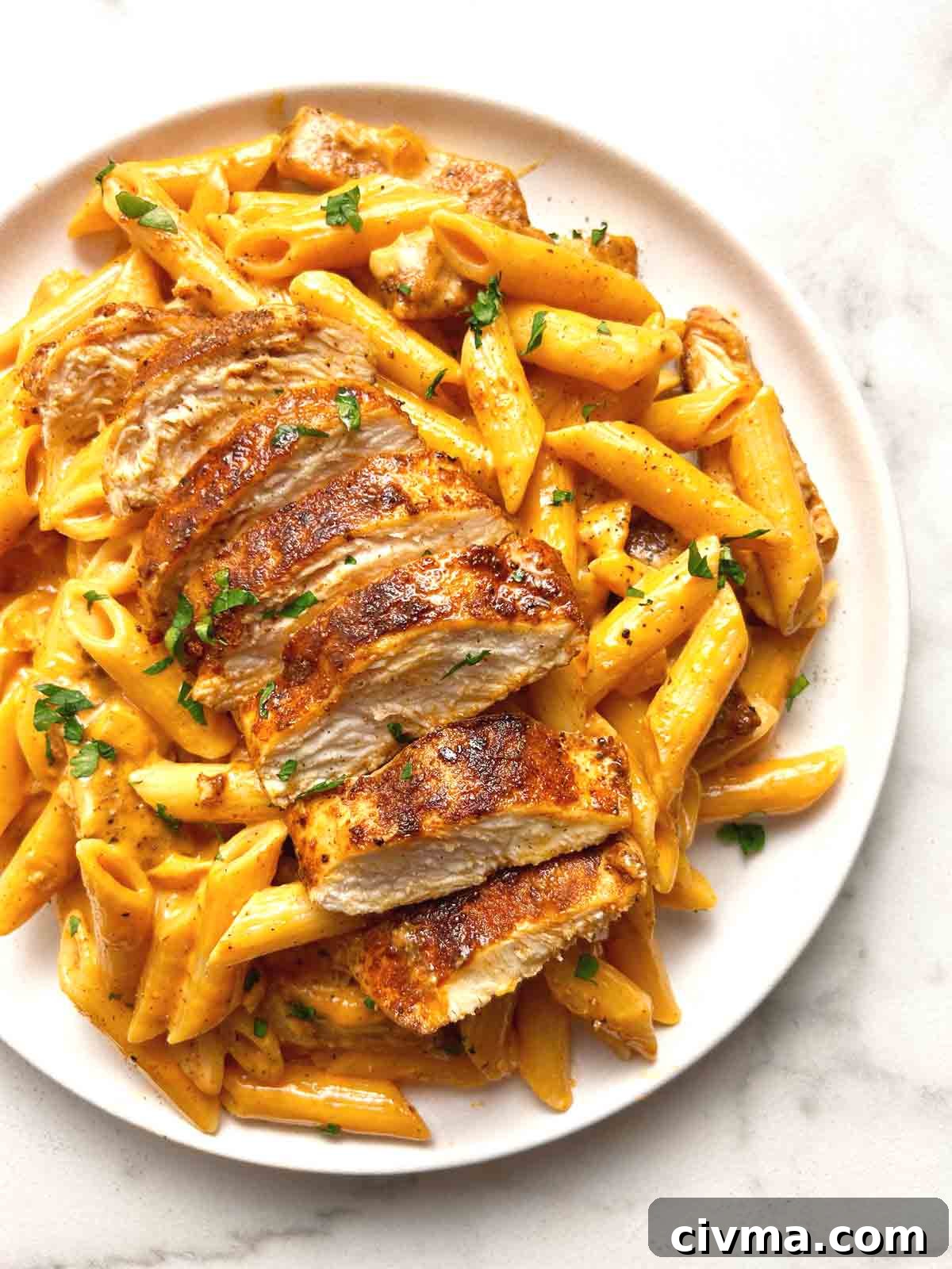 close up of cajun chicken pasta on plate.