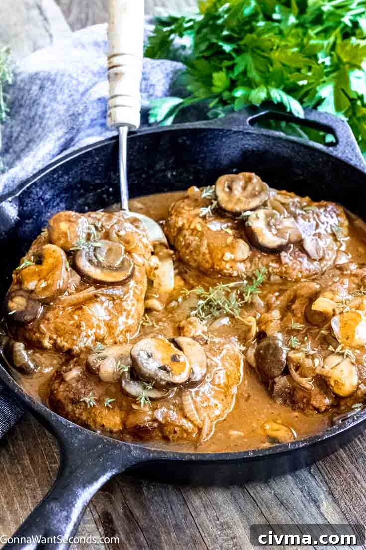 easy salisbury steak recipe with brown gravy in a cast iron skillet