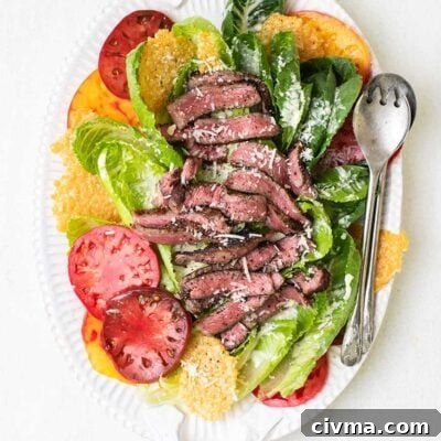 A platter with tomatoes, romaine lettuce, and steak.