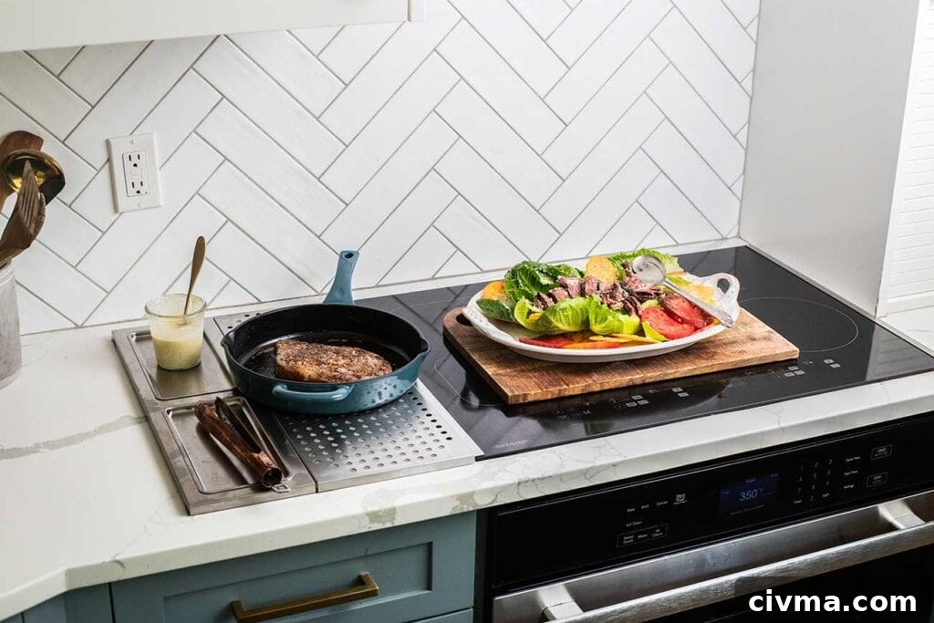 A Sharp Induction Cooktop with a salad and a steak in a cast iron pan.