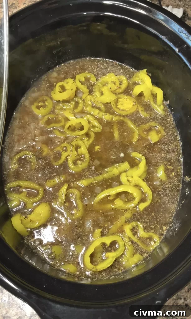Peppers added to Italian beef in the slow cooker