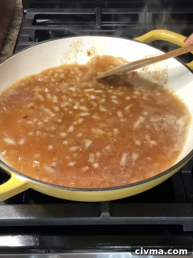 Onions, garlic, and beef broth for Crockpot Italian Beef Sandwiches