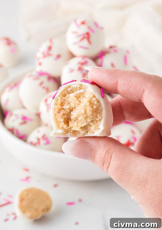 hand holding sugar cookie Valentine truffle with bite