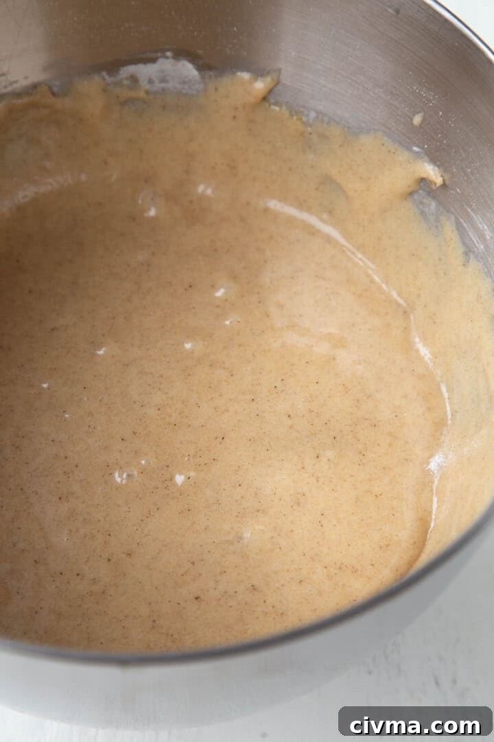 brown batter with cinnamon in a metal bowl.