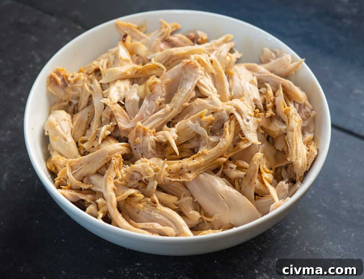 Spicy Chicken Noodle Soup Recipe 12 shredded chicken in bowl tossed with pepper and soy sauce.