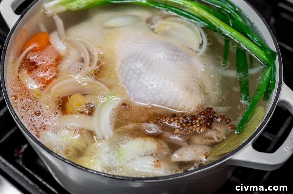 Spicy Chicken Noodle Soup Recipe 7 whole chicken in boiling water with aromatics.
