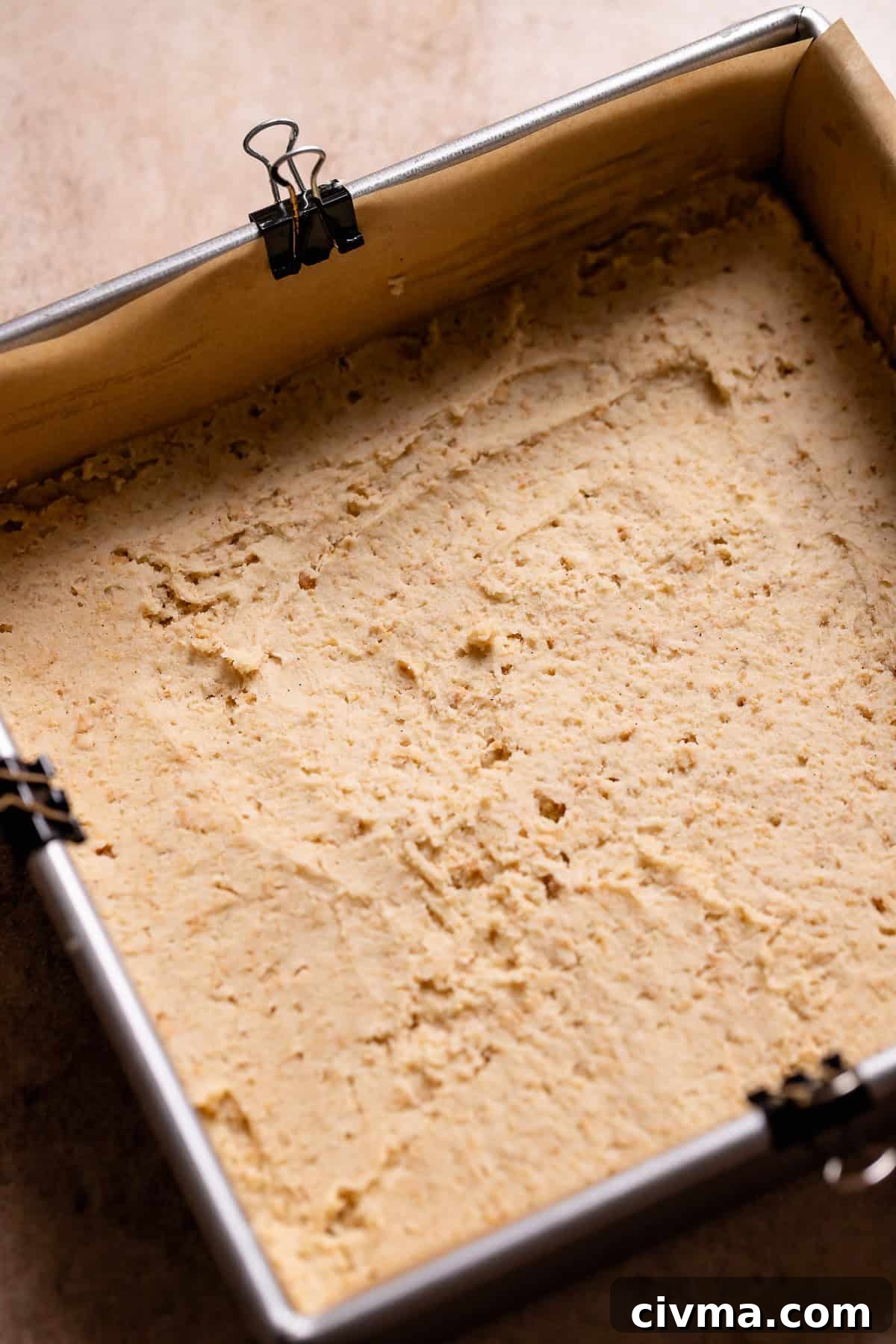 Soft Gooey Smores Cookie Bars Recipe 5 Graham cracker cookie dough spread into the bottom of a metal baking pan.