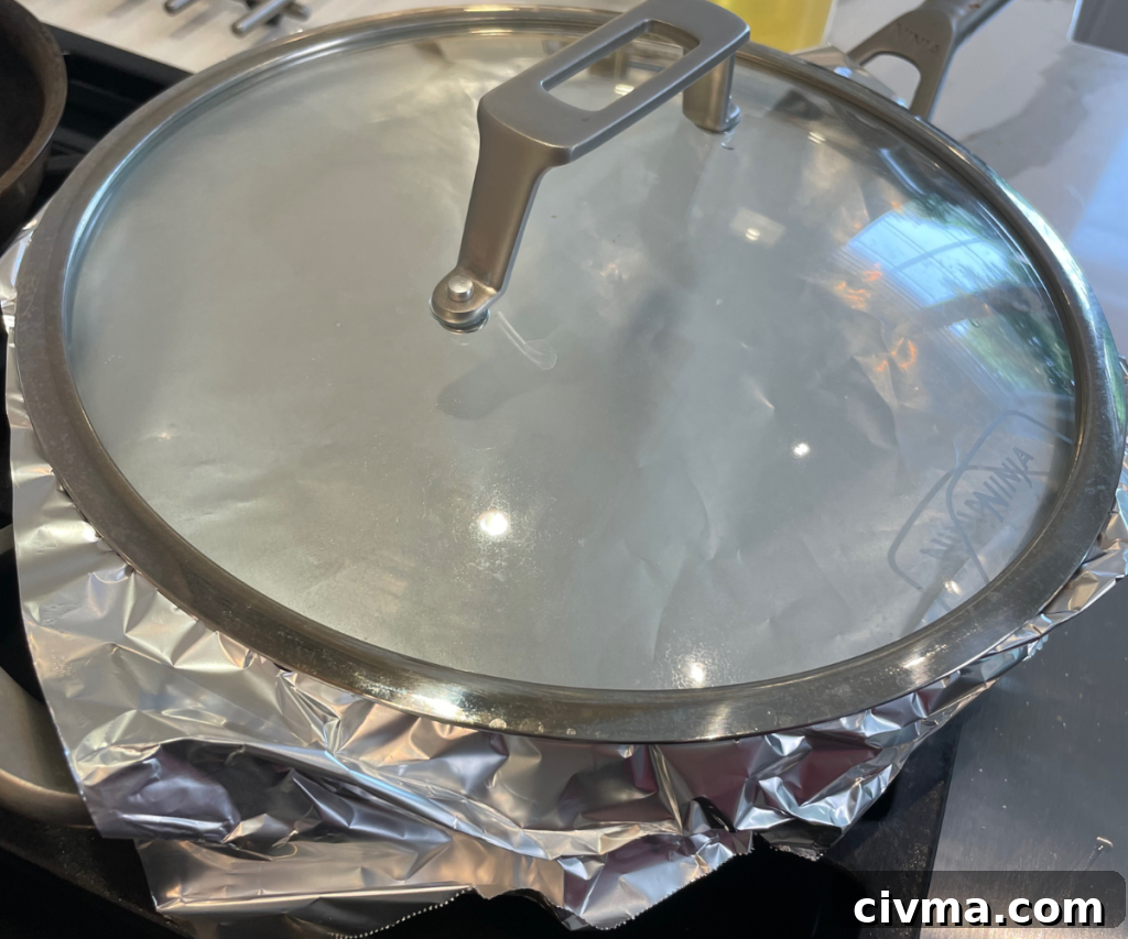 Jollof rice simmering in pan