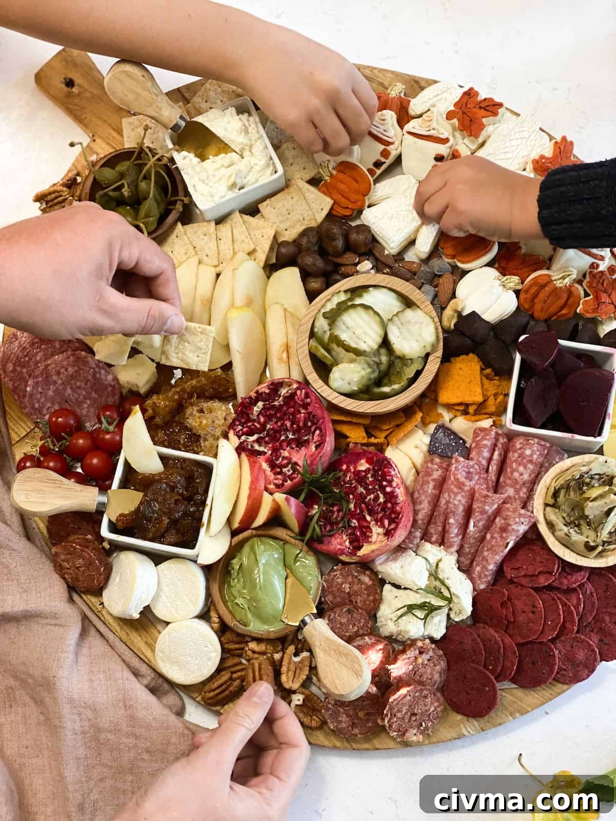 Create a Stunning Thanksgiving Charcuterie Board 9 Hands eating Thanksgiving charcuterie board
