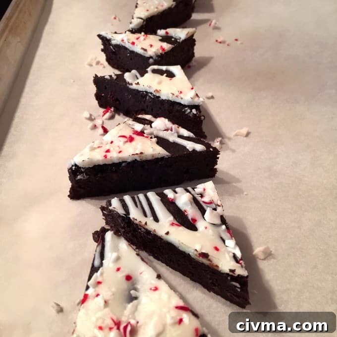 Peppermint Chocolate Brownie Triangles topped with icing and crushed candy canes.
